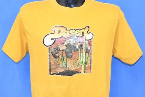 A yellow shirt with a desert picture on it Description automatically generated