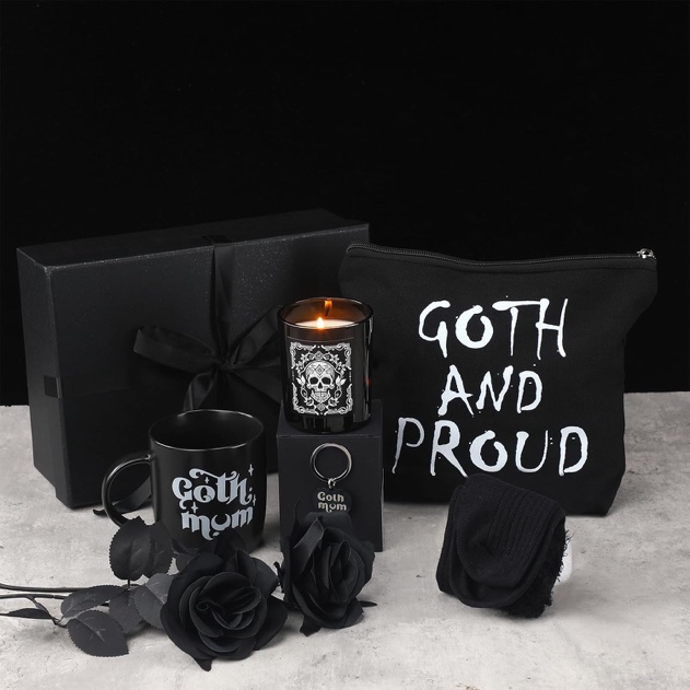 A black box with a candle and a black bag with black roses Description automatically generated